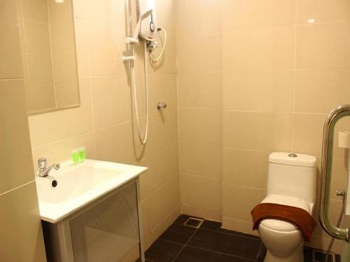 a bathroom with a shower and a toilet and a sink at Rock & Roll Hotel Klang in Klang