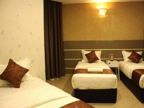 a hotel room with two beds in a room at Rock & Roll Hotel Klang in Klang