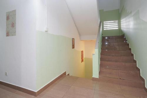 a hallway with a staircase in a building at OYO 90106 Sindbad Hotel in Kuala Lumpur