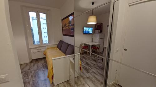 una pequeña sala de estar con sofá y ventana en Milano IEO, Prada, Università Bocconi, Duomo, Assago Forum, en Milán