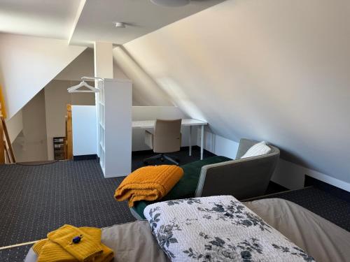 an attic room with a bed and a desk at Ferienwohnung Vierjahreszeiten Herbst in Bad Langensalza
