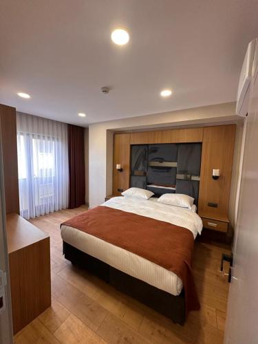 a bedroom with a large bed in a room at Questa Deluxe Hotel in Trabzon