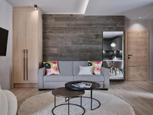 a living room with a couch and a table at Hotel Garni Pinzgau, Fabian Hüttl in Neukirchen am Großvenediger