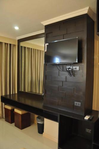 a room with a television on a wall at Hotel Lapira Vigan in Vigan
