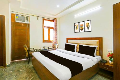 a bedroom with a large bed in a room at Super Hotel O Sector 45 Formerly Manyavar in Chandīgarh