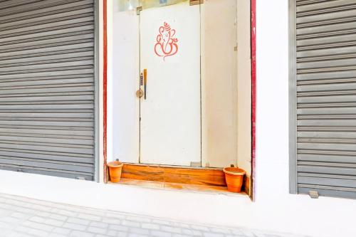 a window with a door with a sign on it at Super Hotel O Sector 45 Formerly Manyavar in Chandīgarh