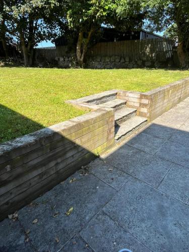 a brick retaining wall with steps in a yard at Historic House in Sandyford Village in Dublin