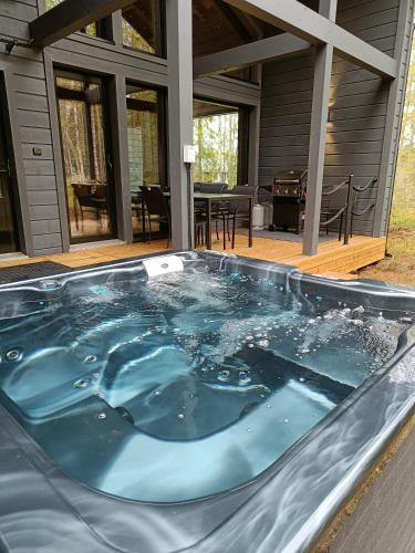 a hot tub on the deck of a house at Villa Syöte in Syöte