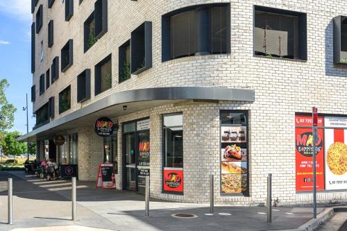 a building with a pizza restaurant on a street at Penrith 2Br apt close toTrain station Shopping in Penrith