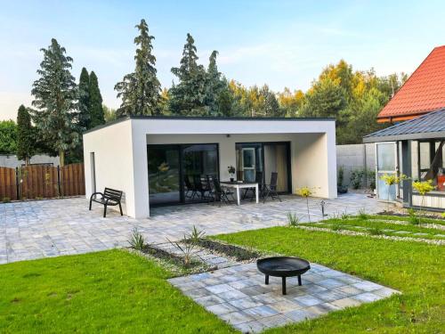 a patio with a table in a yard at Biała mewa in Huta