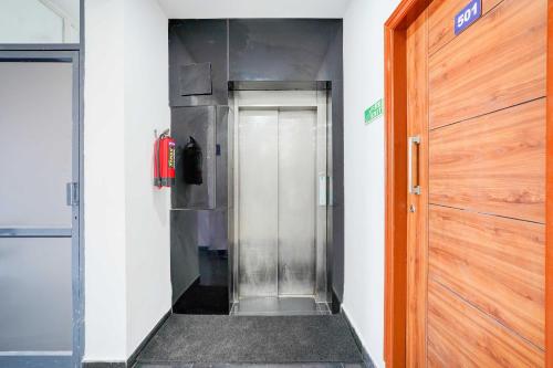 a elevator in a building with a metal door at Collection O Jeevan Bima Nagar HAL Road in Bengaluru