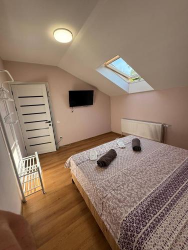 a bedroom with a bed and a television and a window at Like Hostel in Chişinău