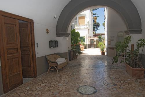an entrance to a building with a chair and a door at Medo Dimora Mediterranea - Casa Manouel in Vico Equense