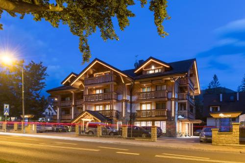 a large building on a street at night at Hotel Foluszowy Potok in Zakopane
