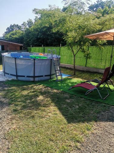a small pool with a table and a chair in a yard at Kod Štefa in Jalžabet