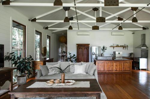 a living room with a couch and a table at The Boathouses at Leaves & Fishes in Lovedale