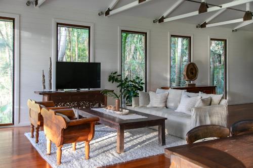 a living room with a couch and a table at The Boathouses at Leaves & Fishes in Lovedale