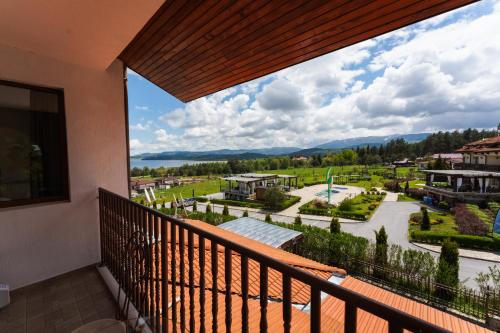a balcony with a view of a town at Family Hotel The View & SPA in Tsigov Chark