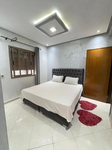 a bedroom with a large bed and a red rug at Sunrise Private Apartment in Marrakech