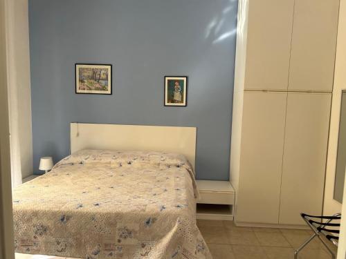a bedroom with a bed in a white room at Casa Rosetta Affittacamere in Iesi