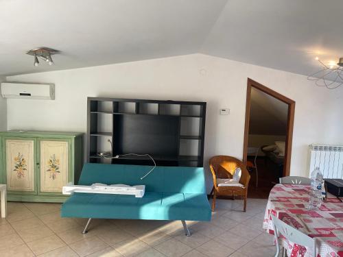 a living room with a blue table and a tv at Villino IRMA in Porto San Giorgio