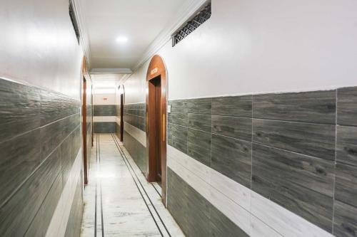 a hallway with wood paneled walls and a door at Collection O Pithampur in Indore