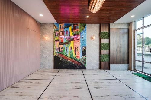 a hallway with a large painting on the wall at Collection O Pithampur in Indore