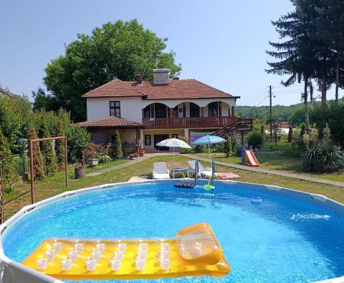 a swimming pool in front of a house at Vila Jagoda in Bojnik
