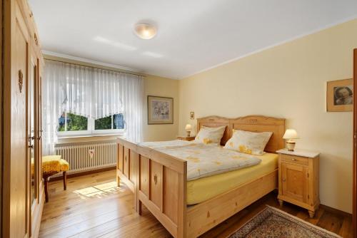 a bedroom with a large bed and a window at Ferienwohnung Waltraud in Tieringen