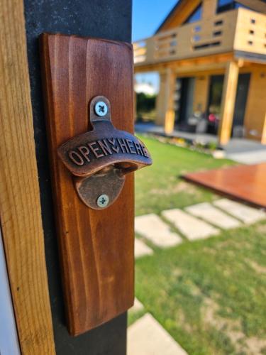 a wooden doorhandle with a sign on a house at RAOS Cottage in Ulcinj