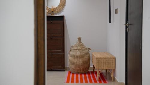 a room with a vase and a chair on a rug at Cityscape & Coastal Charm Elegant 2br Seaside in Dubai Marina