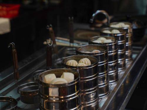 a row of tin cups filled with dumplings at Hampton by Hilton Dongguan Fenggang in Dongguan