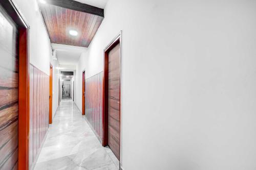 a corridor with wooden doors in a building at Collection O DTU Main Gate Delhi in New Delhi