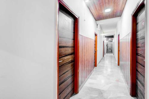 a corridor with wooden doors in a building at Collection O DTU Main Gate Delhi in New Delhi