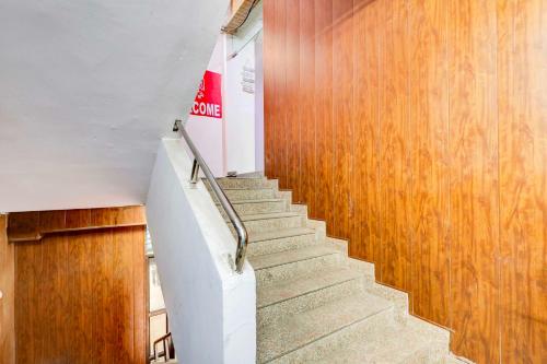 a staircase in a building with wooden walls at Collection O DTU Main Gate Delhi in New Delhi