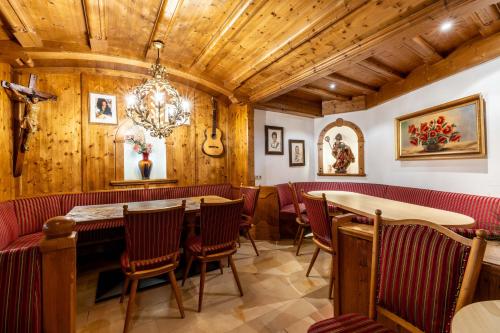 a restaurant with wooden walls and tables and chairs at keyone rooms Finkenberg in Finkenberg