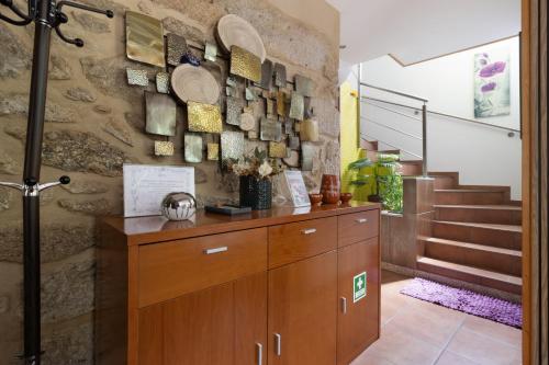 a room with a wooden cabinet and a staircase at Quinta Da Cevidade in Melgaço