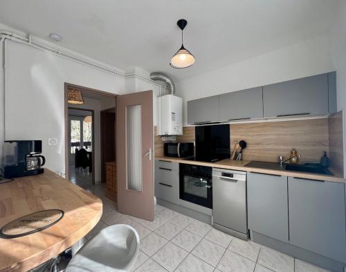 une cuisine avec une table et un comptoir dans l'établissement Beau T3 avec balcon à Perpignan, à Perpignan