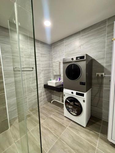 a washer and dryer in a bathroom with a shower at KSL Modern Studio 1-2Pax #Daya#Austin#Ikea#Aeon in Johor Bahru
