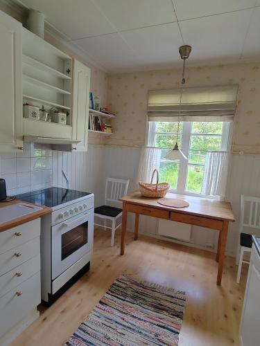 a kitchen with a table and a counter top at Väentupa in Kaarina