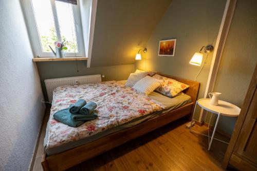 a bedroom with a bed with a pair of shoes on it at SeeZauber- gemütliche Ferienwohnung, Privatparkplatz, Cospudener See in Markkleeberg