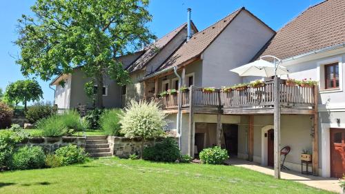 a house with a deck and a yard at Penzion Pršutérie® in Litoměřice