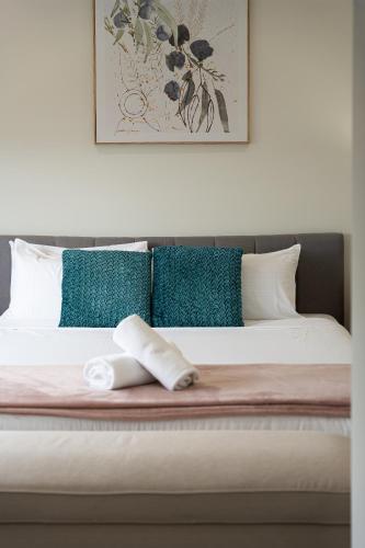 a bed with a towel on top of it at Austral Spacious large 5 br home with Central AC in Austral
