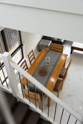 an overhead view of a dining room table and chairs at Austral Spacious large 5 br home with Central AC in Austral