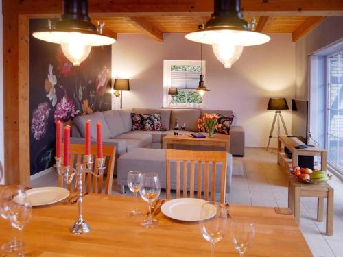 a dining room and living room with a table and chairs at Ferienpark Scharmützelsee in Wendisch Rietz