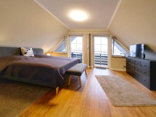 a bedroom with a bed and a dresser and windows at Ferienpark Scharmützelsee in Wendisch Rietz