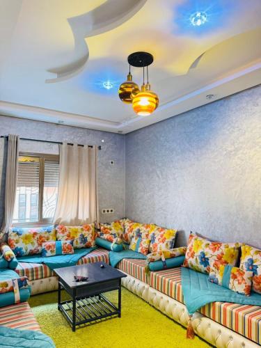 a living room with couches and a table at Sunrise Private Apartment in Marrakech