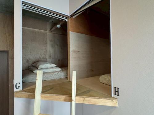 a room with two bunk beds in it at 石垣ゲストハウスオハナ in Ishigaki Island