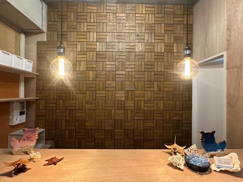 a dining room table with two lights and stars on it at 石垣ゲストハウスオハナ in Ishigaki Island