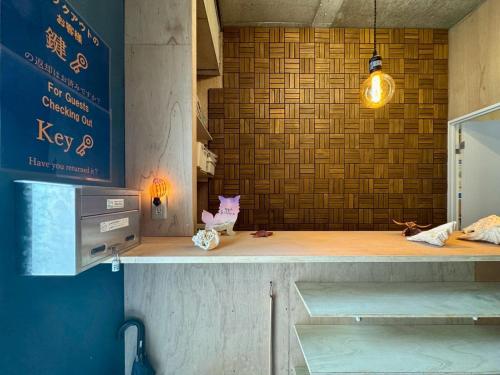 a kitchen with a counter with a light on it at 石垣ゲストハウスオハナ in Ishigaki Island